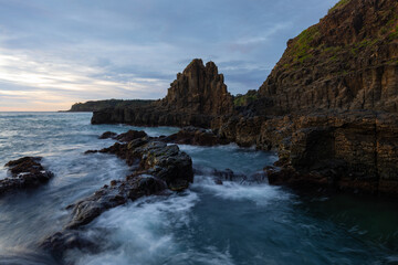 Beautiful rocky coastline with flowing water in the morning.