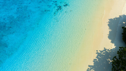 Top view of background for summer vacation concept. Nature of the beach and sea, summer with sunlight, sandy beach The sparkling sea water	