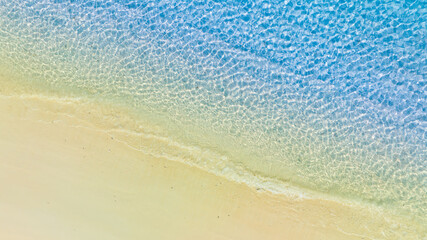 Top view of background for summer vacation concept. Nature of the beach and sea, summer with sunlight, sandy beach The sparkling sea water	