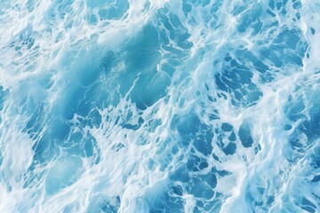 Obraz premium Aerial view of crystalline ocean waves with foamy turquoise surf. Creating a tranquil and serene seascape with a pure and clean natural marine backdrop