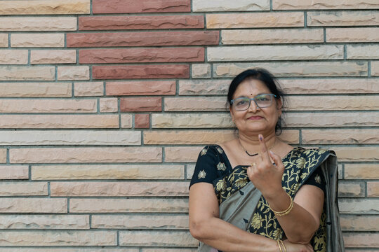 Picture of an Indian woman showing her finger after casting vote in election. Lok sabha, vidhan sabha, polls, election commission of india, technology, democarcy, voice, choice, rajasthan, maharashtra