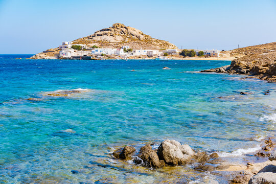 Paraside Beach in Mykonos, Greece, umbrella and luxury beach chairs beds in front of blue ocean. Most famous beach with crystal water and beach music bars. Gimbal cinematic ProRes graded from Log