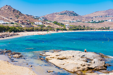 Naklejka premium Kalafatis Beach in Mykonos, Greece. Kalafati is the beach most loved for water sports such windsurf, kitesurf, diving and snorkeling. Near the awesome view of Dragnoisi Island and Divounia,