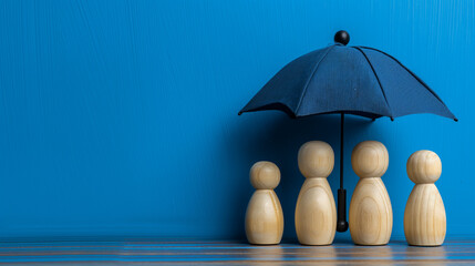 Insurance agent protecting family with umbrella over wooden peg people