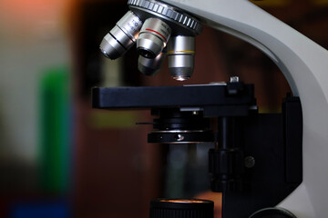 Compound Microscope focuses on the objective lens. It is a biology laboratory equipment used to magnify small objects into larger images.