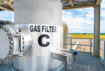 Natural gas cleaning filter with beautiful landscape in the background. Eco-friendly production...