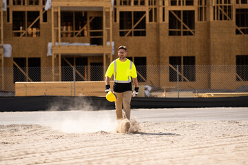 A construction worker in highvisibility gear emphasizes safety and professionalism at a dusty work...