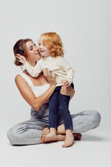 Bonding moment mother and daughter embracing on the floor in a heartwarming family scene of love and connection