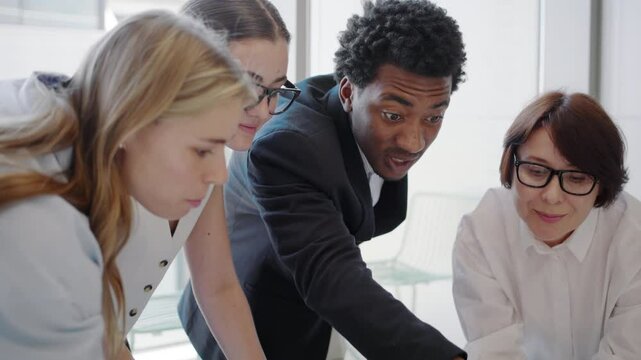 A team of diverse young professionals is engaged in a successful collaborative business meeting, fostering a dynamic corporate environment with innovative ideas and efficient communication