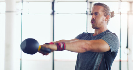 Gym, kettlebell and man with strength for power, weight lifting and endurance for arms workout....
