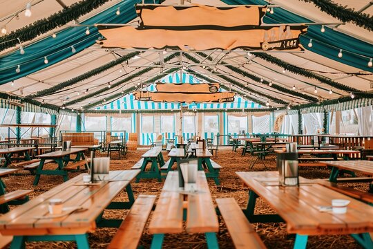 Oktoberfest beer festival in Munich. Inside Augustiner beer tent, people drinking in traditional Bavarian,