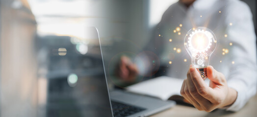 Business global internet connection application technology and digital marketing. Man hand holding Light bulb Global Internet connection. Financial and banking, Digital link tech, big data.