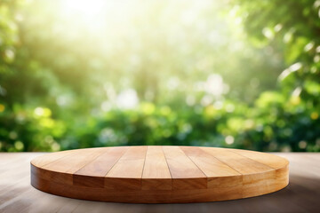 Empty round wooden tabletop providing space for product placement on blurred green nature background