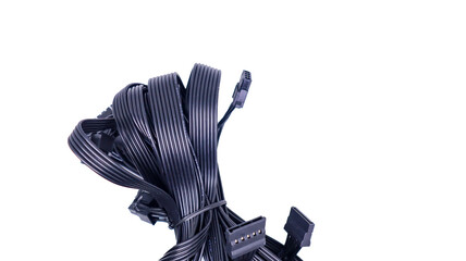 A tangled bundle of black PC cables with connectors isolated on a white background. Black PC Cables...