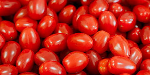 Cherry tomatoes for sale on a market or supermarket stall.