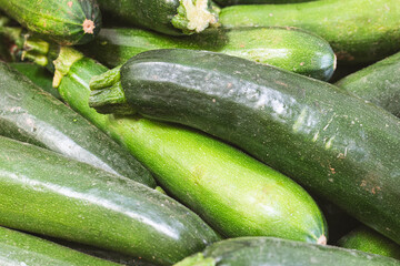 Close-up zucchini for sale at a market or supermarket stall.