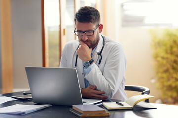 Male person, doctor and laptop with planning, ideas and thinking in office as medical professional. Man, pediatrician and diagnosis, telehealth and technology for patient records, medicine or surgery