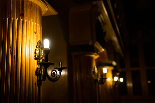 Antique lamp on wall column at night decorate inside hotel