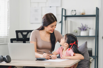 mother teaching daughter and helping her with homework at home. education, family and homework concept