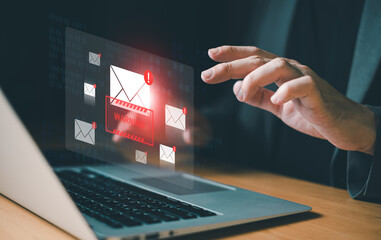 Business man using smartphone and computer that show warning sign after got attack phishing email...