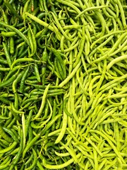 A heap of organic beans and chilli peppers. Natural vegetable background. Healthy plant food pattern