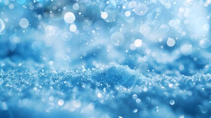 Light snow bokeh background on shiny glitter light blue snow winter for Christmas festive background. 