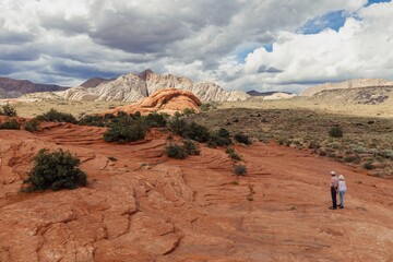 People walking on rocky landscape in Snow Canyon, Ivins, Utah, United States of America. © Zenstratus