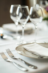 Elegant table setting with wine glasses is waiting for guests at restaurant