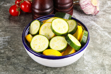 Sliced raw young green and yellow zucchini