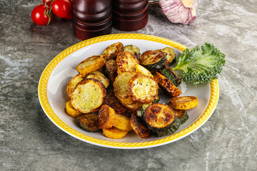 Roasted young zucchini in the plate