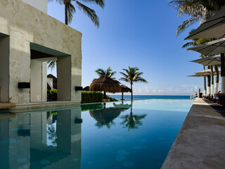 Relaxing pool of a luxury resort hotel, with a beach of fine white and golden Caribbean sand,...