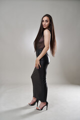 Beautiful hispanic woman on gray background