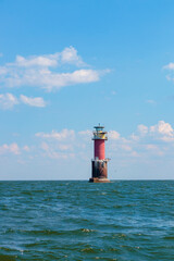 A lighthouse standing in the Baltic Sea in the Gulf of Finland near Tallinn, Estonia. Blue morning...