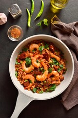 Creole jambalaya with prawn, smoked sausages and vegetables in cooking pan