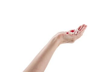 Fototapeta premium Mid aged female hand full of red and white pills isolated on white