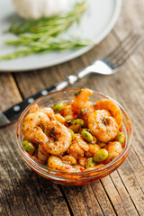 Fresh salad with shrimps and edamame soybeans in bowl on wooden table.