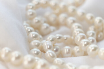 Pearls are scattered gracefully on a light backdrop, their muted glow symbolizing a soft elegance. Their natural essence stands as a tranquil rebellion against today s fast-paced, artificial reality.