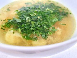 Tasty soup with parsley leaves.