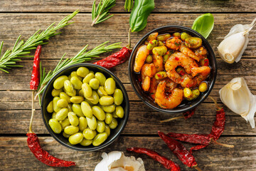 Fresh salad with shrimps and edamame soybeans in bowl on wooden table. Top view.