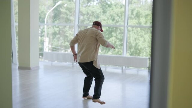 Man Breakdancing in Modern Studio