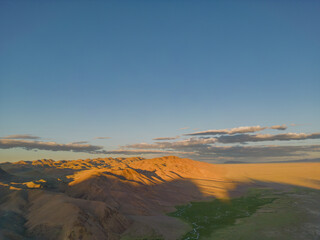 The golden Hour in the desert. Blue sky at sunset in the desert. Mountains at sunset.