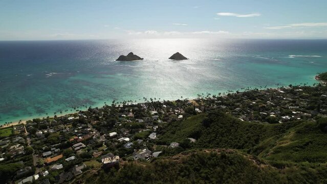 Aerial drone video over Lanakai Pillbox of Kailua Bay and Na Mokolua off the windward coast of Oahu
