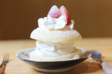plate of ice cream with strawberries and whipped cream.