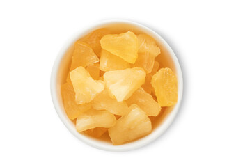 Ceramic bowl with sweet dried soft pineapple pieces isolated on white background.Top view.
