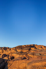 Scenic moon-like landscape of a rocky cliff and clear blue sky in &Aring;land Islands, Finland, on a sunny evening in the summer. Off the beaten path in the nature. Copy space.
