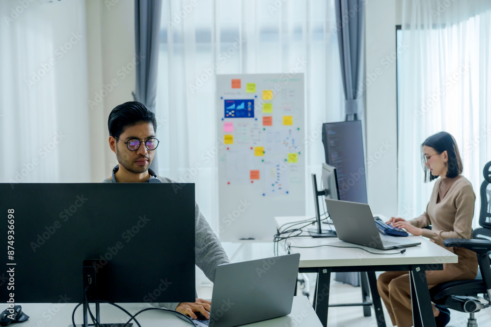 Wall mural asian woman and indian man developer team working about programming software data online at office