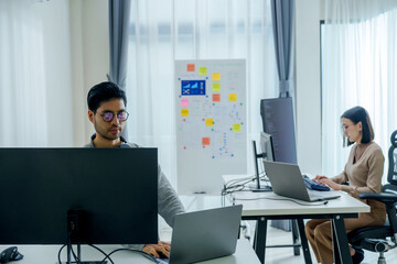 asian woman  and Indian man Developer team working  about programming software data online at office