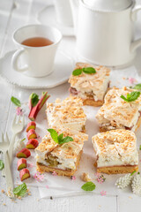 Homemade and tasty rhubarb yeast cake with crumble and foam.