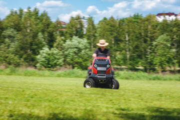 Man on lawn tractor mowing lawn on backyard. The red rider. The lawnmower tractor. High quality 4k footage
