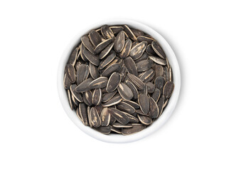 Bowl with healthy black sunflower seeds with shell isolated on white background.Top view.